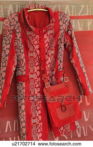 Picture - Coat and shoulder bag on coat hanger. Fotosearch