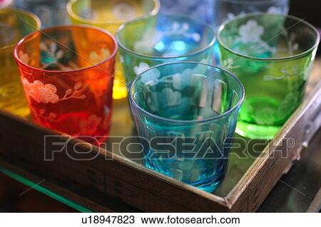 Stock Image - Colored glasses on tray. Fotosearch