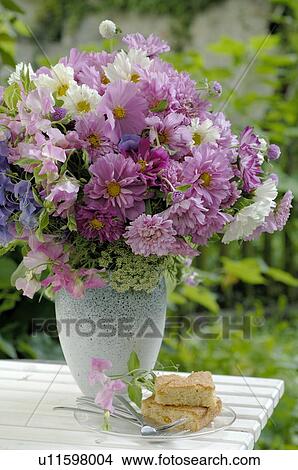Colorful bunch of flowers on garden table View Large Photo Image Picture - Colorful bunch of flowers on garden table. Fotosearch