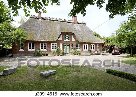 Stock Photography - Country house with thatched roof. Fotosearch