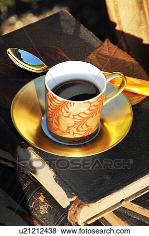 Cup of coffee on book outdoors View Large Photo Image Stock Photo - Cup of coffee on book outdoors. Fotosearch