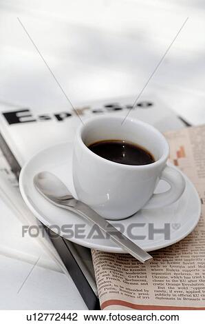 Cup of espresso on newspaper View Large Photo Image Stock Image - Cup of espresso on newspaper. Fotosearch