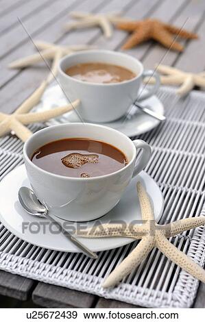 Stock Photo - Cups of coffee and decorative starfishes. Fotosearch