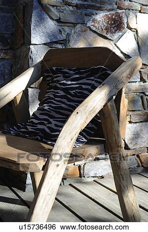 Stock Photograph - Cushion with zebra print on wooden chair. Fotosearch