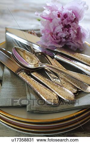 Cutlery and blossom on stack of plates View Large Photo Image Stock Image - Cutlery and blossom on stack of plates. Fotosearch