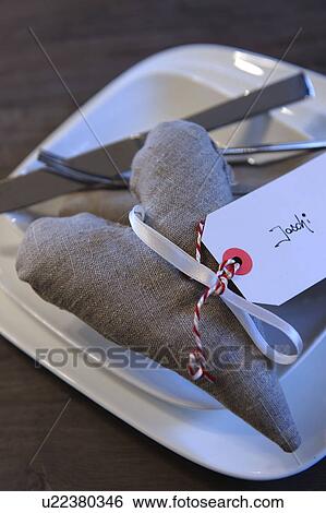 Stock Photograph - Decorative heart with name tag on plate. Fotosearch