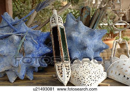Stock Image - Decorative seashells and windlights. Fotosearch
