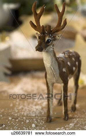 Stock Image - Deer figurine and fake snow. Fotosearch