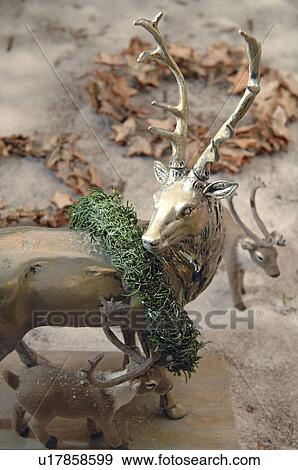 Stock Photo - Deer figurine with wreath. Fotosearch
