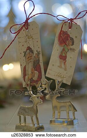 Stock Image - Deer figurines and gift tags. Fotosearch