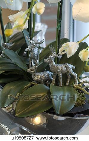 Stock Photo - Deer figurines in potted plant. Fotosearch