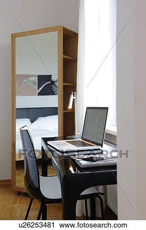 Stock Image - Desk with laptop at the window. Fotosearch