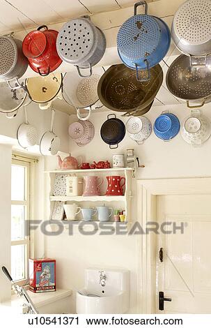 Stock Image - Different sifters hanging on ceiling. Fotosearch