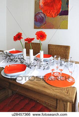 Stock Photograph - Dining table with champagne glasses, plates and flowers. Fotosearch