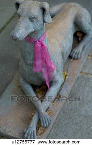 Dog statuette with ribbon around his neck View Large Photo Image Stock Photo - Dog statuette with ribbon around his neck. Fotosearch
