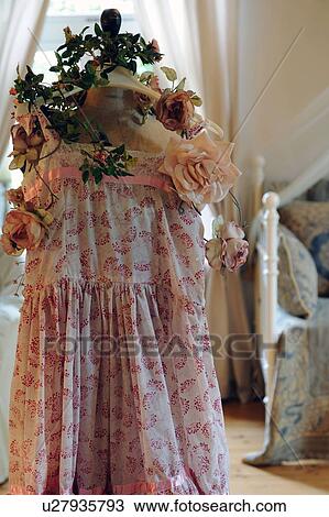 Stock Image - Dress and rose blossoms on coat hanger. Fotosearch