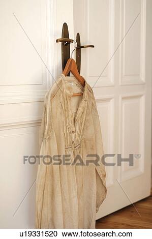 Dress on clothes hanger by the door View Large Photo Image Stock Image - Dress on clothes hanger by the door. Fotosearch