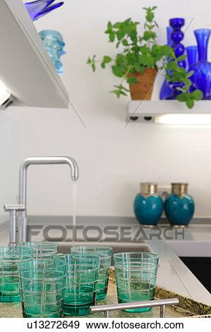 Drinking glasses at sink in kitchen View Large Photo Image Stock Photo - Drinking glasses at sink in kitchen. Fotosearch