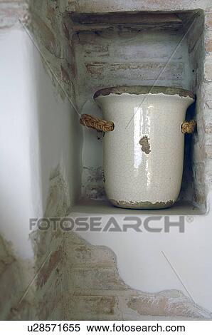 Stock Photography - Earthenware jug in a niche. Fotosearch