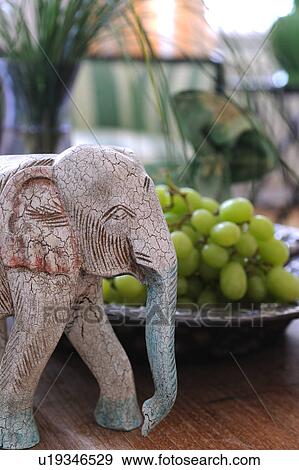 Stock Photo - Elephant figurine and grapes. Fotosearch