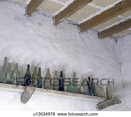 Stock Photo - Empty glass bottles on shelf. Fotosearch