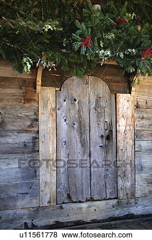 Fir branches above wooden door View Large Photo Image Stock Photo - Fir branches above wooden door. Fotosearch