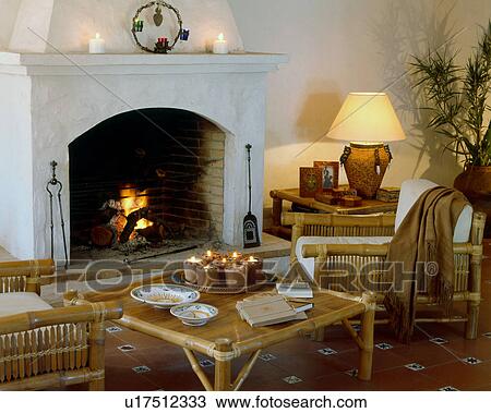 Stock Image - Fireplace room with rattan furniture. Fotosearch
