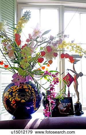 Stock Photo - Flowers and decoration in windowsill. Fotosearch