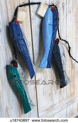 Four fish figures hanging at handle View Large Photo Image Stock Photo - Four fish figures hanging at handle. Fotosearch