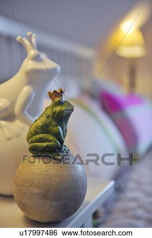 Frog figurine with crown sitting on ball View Large Photo Image Stock Photograph - Frog figurine with crown sitting on ball. Fotosearch