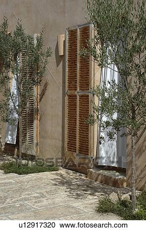 Stock Image - Front door with window shutters. Fotosearch