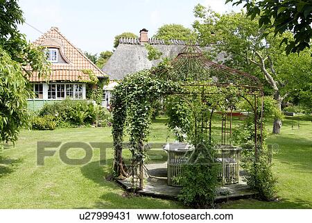 Stock Image - Garden of a country house. Fotosearch