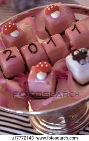 Stock Image - Garnish on confectionary at New Years Eve. Fotosearch