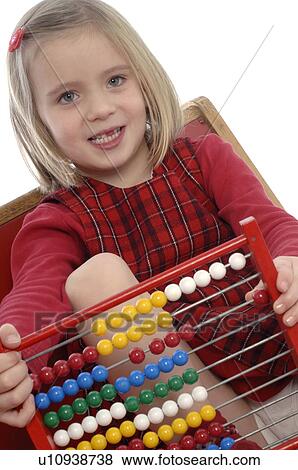 Stock Photo - Girl with abacus on bench. Fotosearch