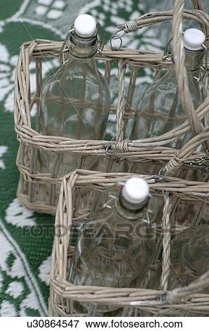 Stock Photo - Glass bottles in baskets. Fotosearch