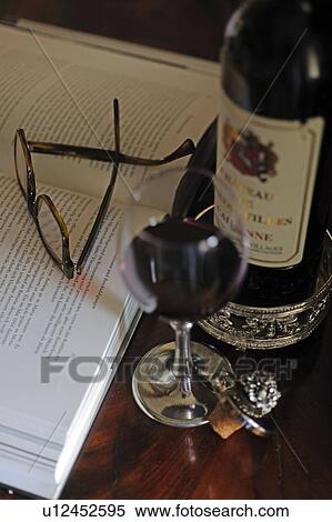Glass of red wine, book and glasses View Large Photo Image Stock Photography - Glass of red wine, book and glasses. Fotosearch