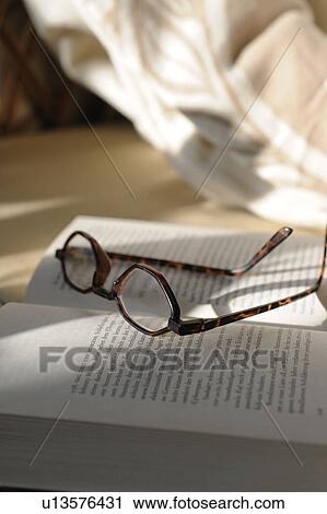 Glasses lying on book View Large Photo Image Stock Image - Glasses lying on book. Fotosearch
