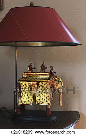 Stock Photo - Golden elephant and table lamp. Fotosearch