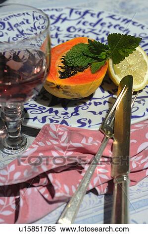 Halved papaya and lemon on plate View Large Photo Image Stock Photography - Halved papaya and lemon on plate. Fotosearch