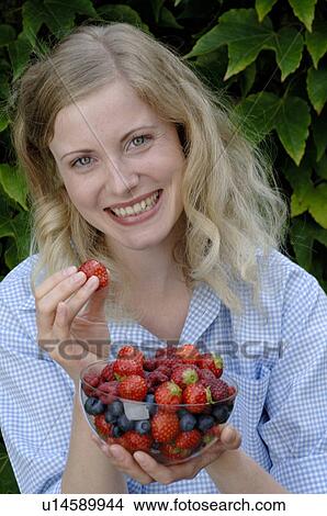 Happy woman holding bowl with fruit View Large Photo Image Picture - Happy woman holding bowl with fruit. Fotosearch