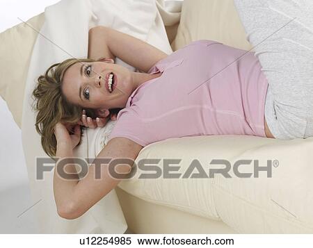 Happy woman lying on couch View Large Photo Image Stock Photography - Happy woman lying on couch. Fotosearch
