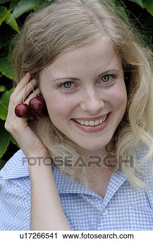 Happy young woman with cherries View Large Photo Image Stock Image - Happy young woman with cherries. Fotosearch