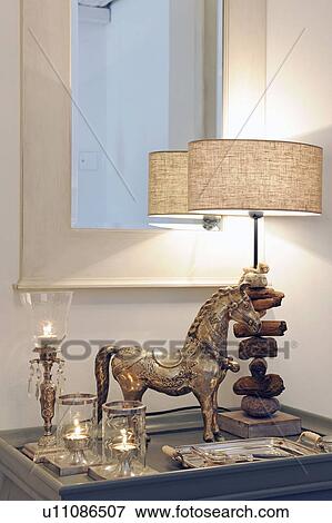 Horse figurine, table lamp and candles at mirror View Large Photo Image Stock Photo - Horse figurine, table lamp and candles at mirror. Fotosearch