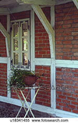 Stock Photography - Jardaniere in front of timber-framed house. Fotosearch