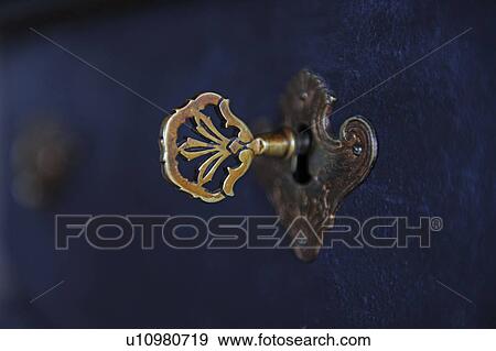 Key in keyhole View Large Photo Image Stock Photo - Key in keyhole. Fotosearch