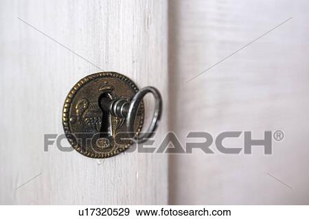 Key in keyhole View Large Photo Image Stock Photo - Key in keyhole. Fotosearch