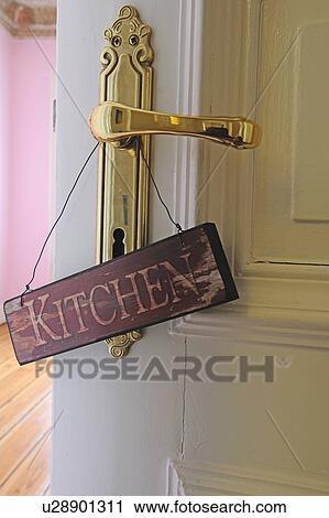Stock Image - Kitchen sign at door knob. Fotosearch