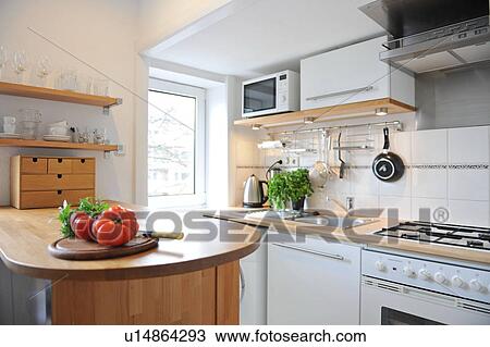 Stock Image - Kitchen with tomatoes on counter. Fotosearch