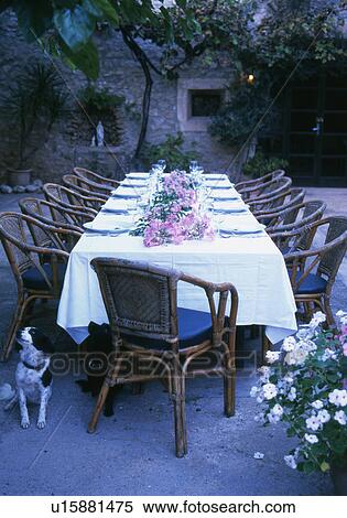 Stock Photography - Laid garden table with flower arrangement. Fotosearch