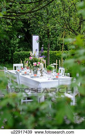Laid table in garden View Large Photo Image Stock Photo - Laid table in garden. Fotosearch
